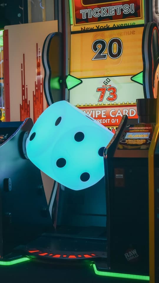 Arcade machines lit up in neon at Twisted Pin